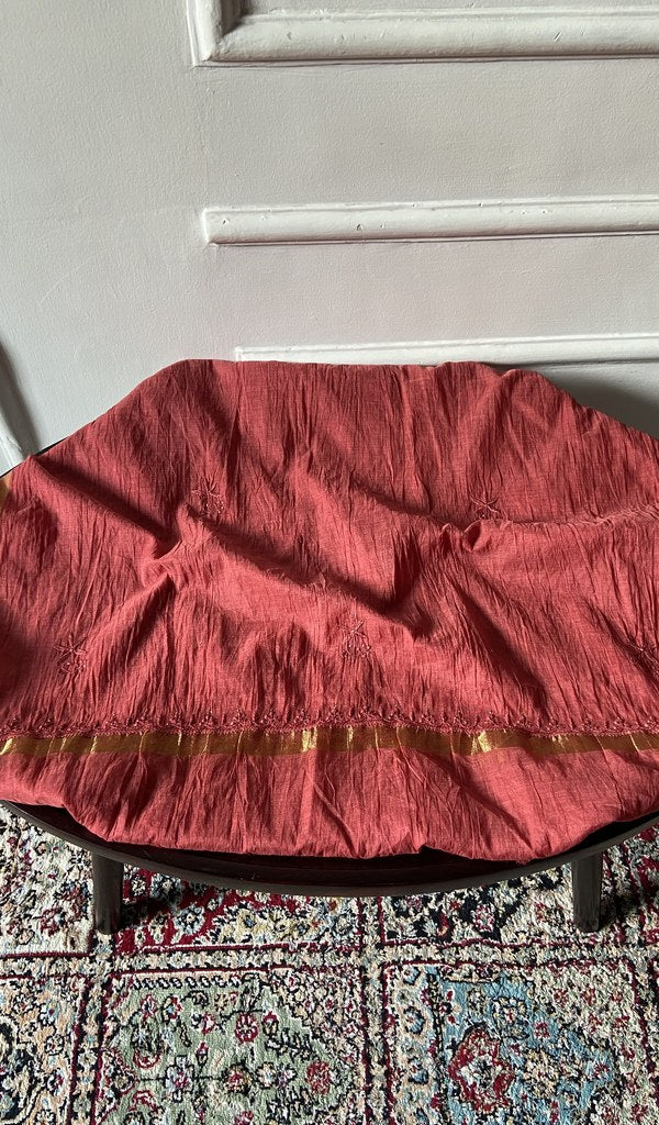 Chikankari across the body of the coral kurta piece