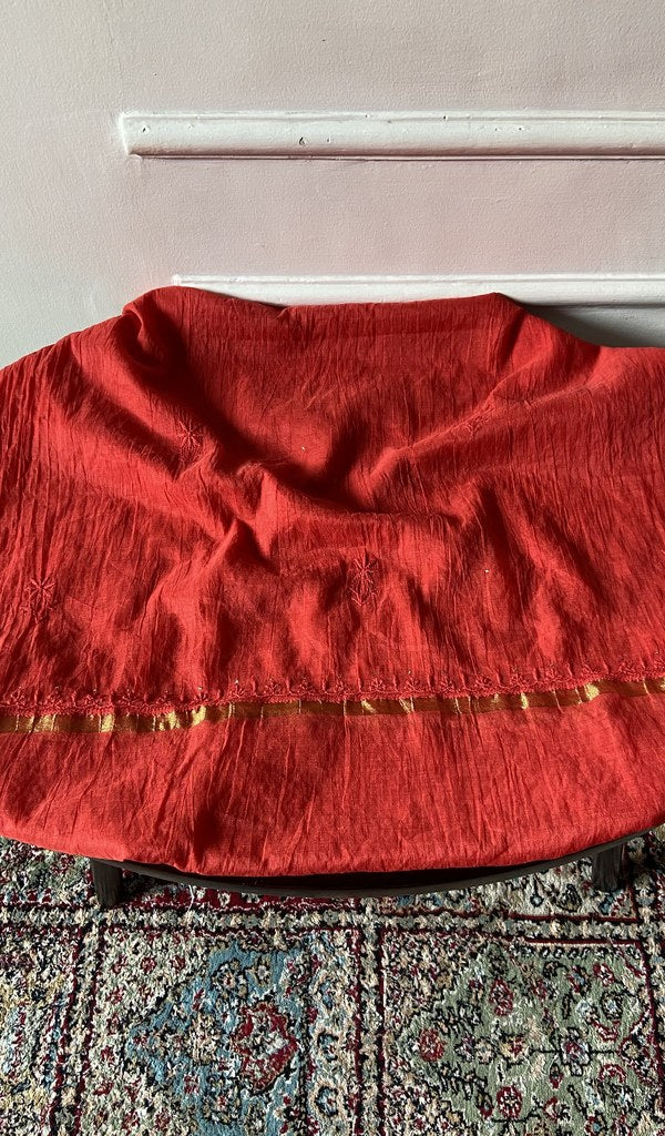 Chikankari across the body of the red kurta piece