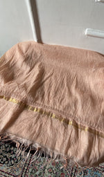 Chikankari across the body of the apricot kurta piece