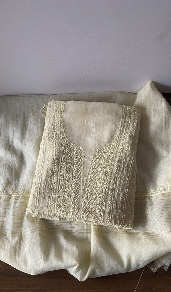 Folded yellow pure mul chanderi kurta piece with chikankari on the panel