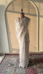 Cream organza silk saree draped on the mannequin, front view