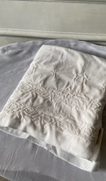 white cotton kurta piece folded, fine chikankari