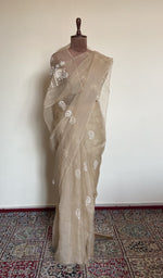 Beige organza silk saree draped on the mannequin, front view