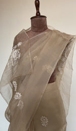 Fine do taar chikankari on border and palla on the beige saree