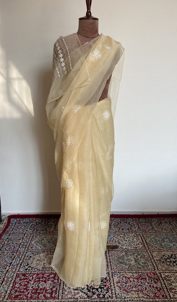 Butter yellow organza silk saree draped on the mannequin, front view