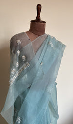 Sky blue saree on the mannequin, close view