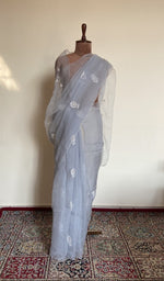 Powder blue organza silk saree draped on the mannequin, front view