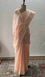 Peach cotton voile chikankari saree draped on the mannequin