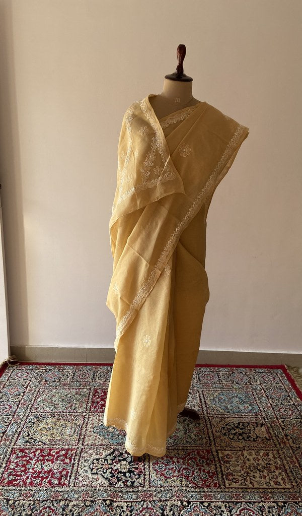 Gold cotton voile chikankari saree draped on the mannequin