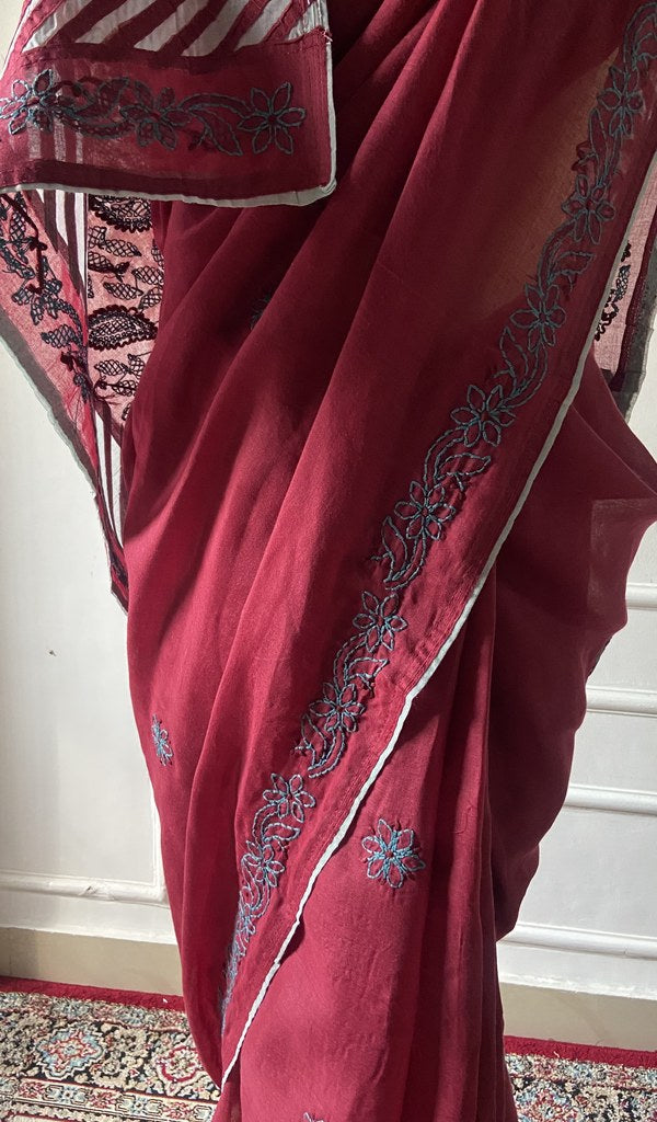 Maroon saree draped to show the fall of the fabric