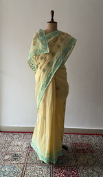 Pale Yellow cotton voile chikankari saree draped on the mannequin