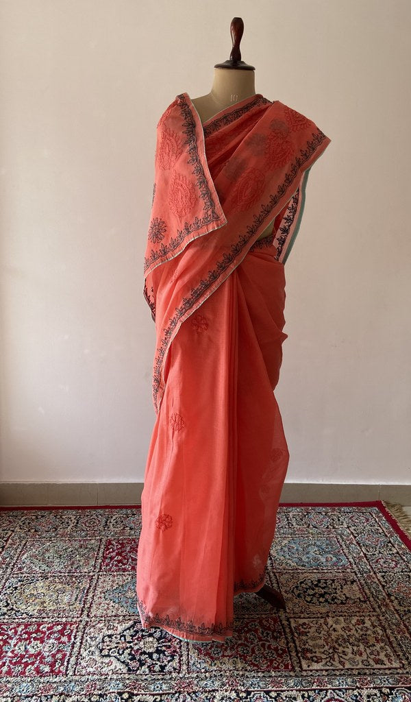 Coral Orange cotton voile chikankari saree draped on the mannequin