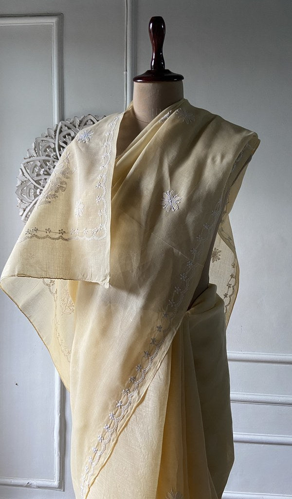 Pale yellow saree draped to show the fall of the fabric