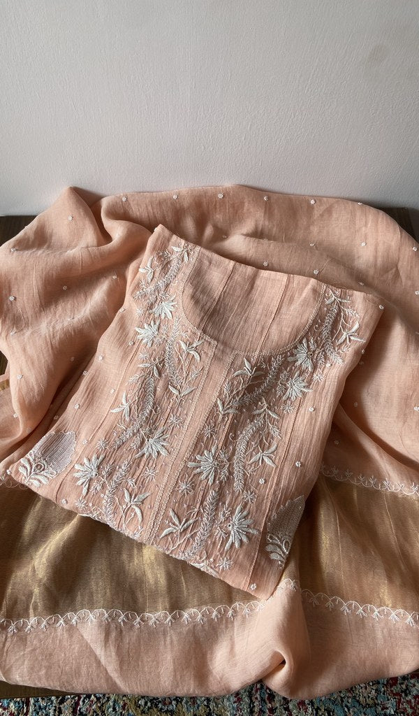 Folded peach pure mul chanderi kurta piece with chikankari on the panel