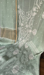 Motifs across the body of the green kurta