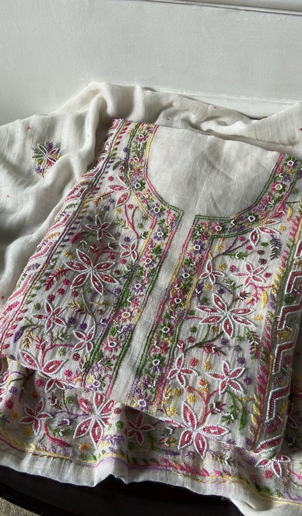 white pure mul chanderi kurta piece folded, fine multicoloured panel chikankari with matching beads sequ