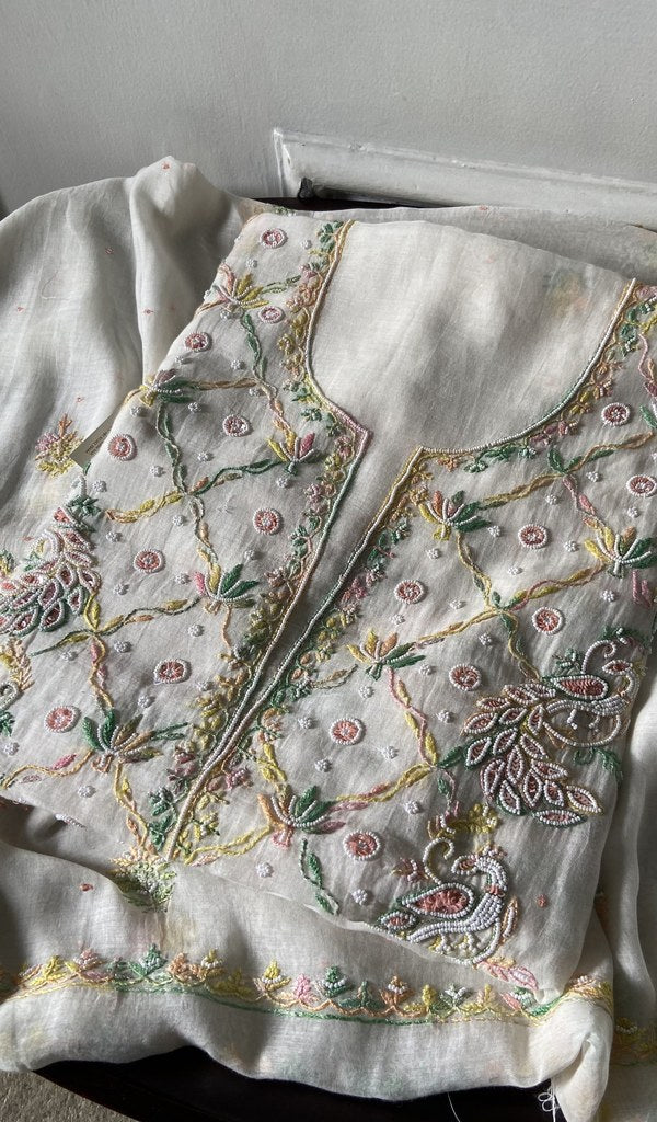 white pure mul chanderi kurta piece folded, fine multicoloured panel chikankari with matching beads sequ