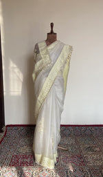 White organza silk saree draped on the mannequin, front view