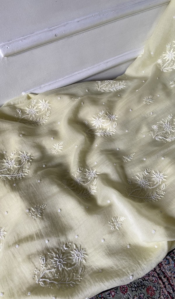 Ivory kurta piece laid out, work across the body