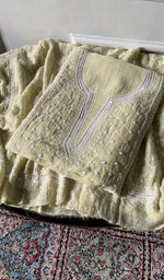 Load image into Gallery viewer, pale yellow chikankari set folded, worked panel on top