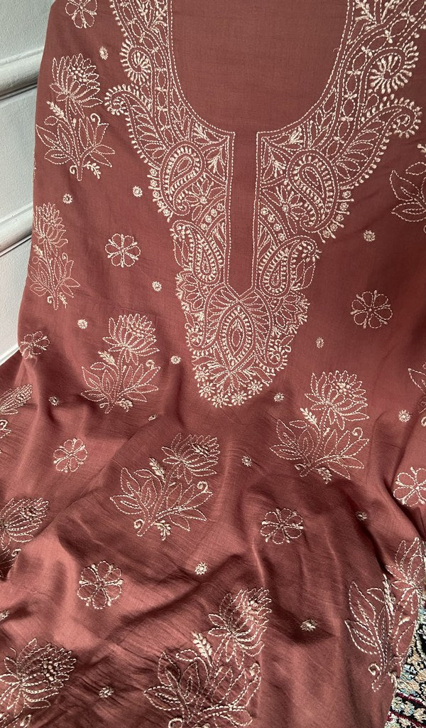 close view of the hand embroidery, rust pure mul cotton