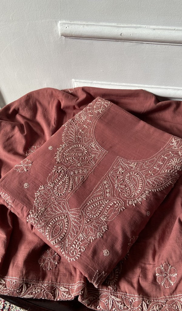 rust chikankari set folded, worked panel on top