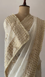 pallu of the off white saree, showing the allover fine badla work with beautiful butterfly motifs and edging/facing on all over