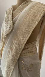 border and edging on the off white pure organza silk saree