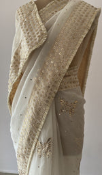 close view of the allover fine badla work with beautiful butterfly motifs and edging/facing on all over