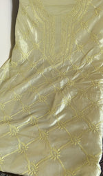 Lemon yellow tussar silk laid flat on the table