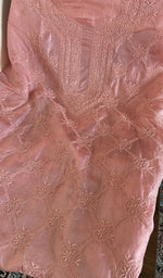 Salmon pink tussar silk laid flat on the table