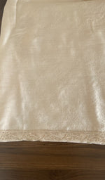 The ivory kurta, spread out flat