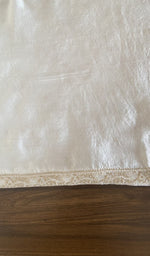 The cream kurta, spread out flat
