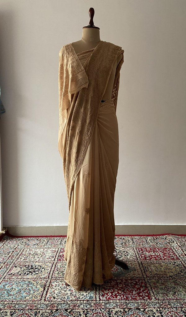 Gold tan viscose georgette saree draped on the mannequin