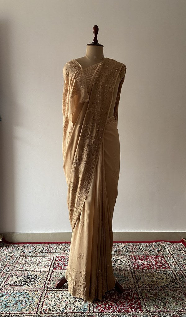 Beige viscose georgette saree draped on the mannequin