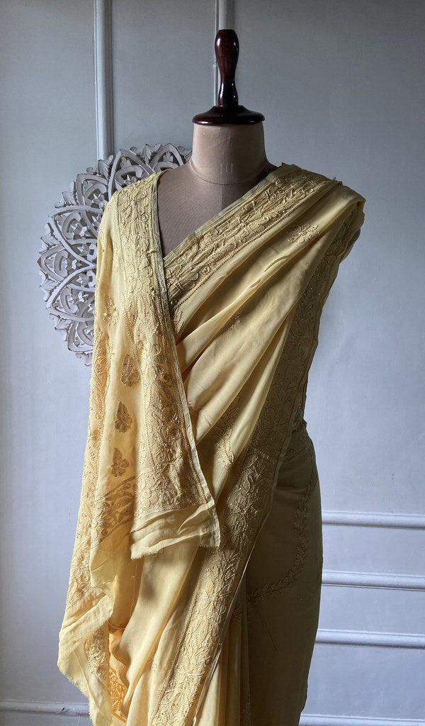pallu of the yellow viscose georgette saree, resham fine chikankari