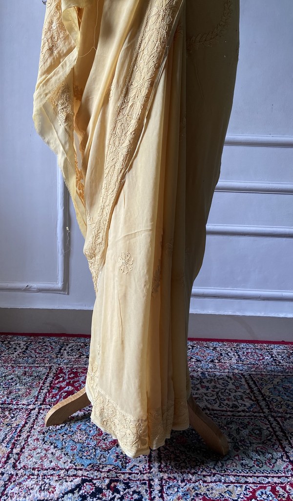 yellow viscose georgette saree seen from the back
