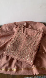 Folded brown pure mul chanderi kurta piece with chikankari on the panel