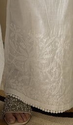 Chikankari at the hem of the white cotton palazzo, close up