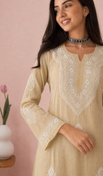 Beige kurti, sleeve and chikankari up close