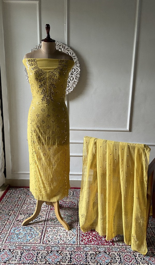 Yellow pure mul chanderi chikankari suit set on the mannequin, dupatta alongside