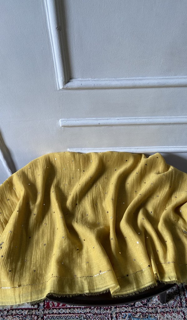 Yellow pure mul chanderi laid over the stool