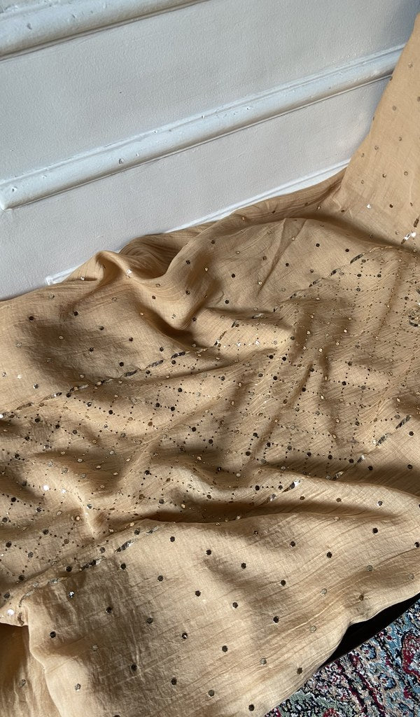 Beige kurta piece laid out, work across the body