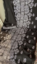 Black faux georgette laid out flat