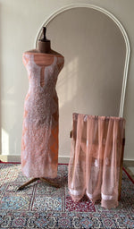 Peach faux georgette set on the mannequin with its dupatta