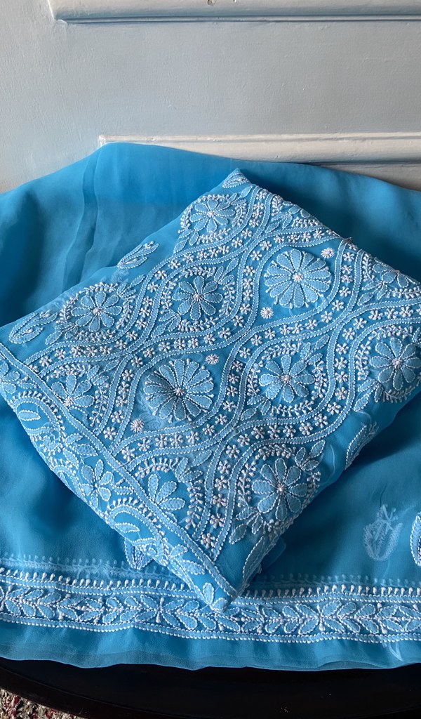turquoise chikankari set folded, worked panel on top