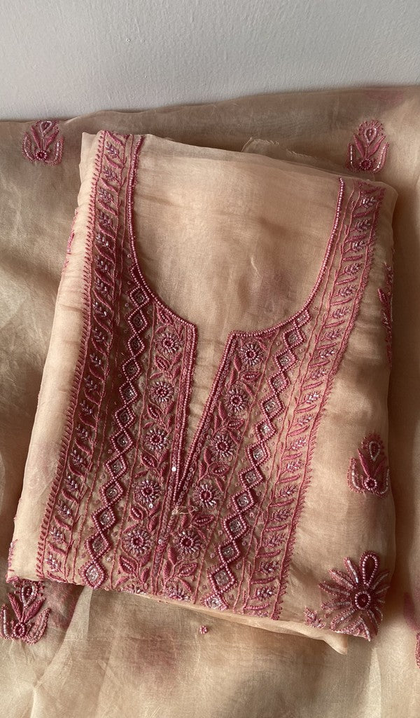 Peach pure organza silk kurta piece folded, fine do taar and teen taar chikankari