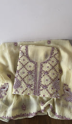 Folded yellow pure mul chanderi kurta piece with chikankari on the panel