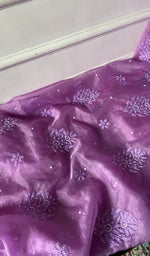 Purple kurta piece laid out, work across the body