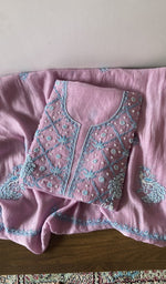 Folded pink pure mul chanderi kurta piece with chikankari in blue thread on the panel